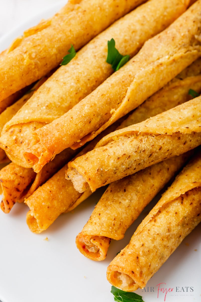 Taquitos that were cooked in an air fryer, on a plate 