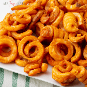 a plate of seasoned air fryer frozen curly fries.