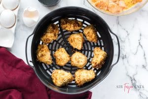 horizontal photo of cooked ninja foodi fried chicken in air fryer basket