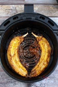 Air fryer glazed banana slices cooked in the air fryer basket