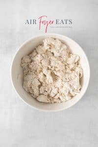 Top view photo of self-rising flour mixed together with Greek yogurt in a white bowl.