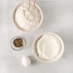 Top view photo of all the ingredients to make air fryer bagels, in separate bowls.