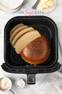 Top view photo of a loaf of Air Fryer Bread in the basket of the Air Fryer.