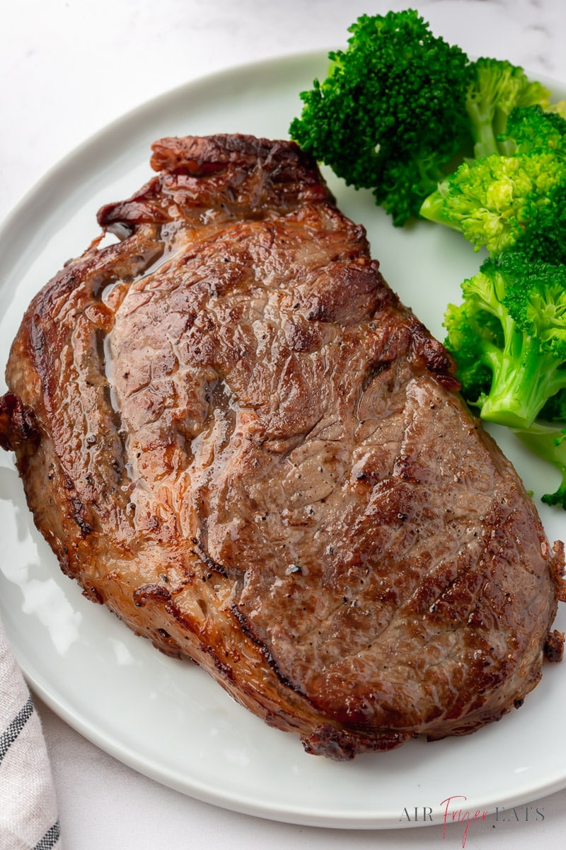 air fryer reheated steak on a plate with a side of broccoli