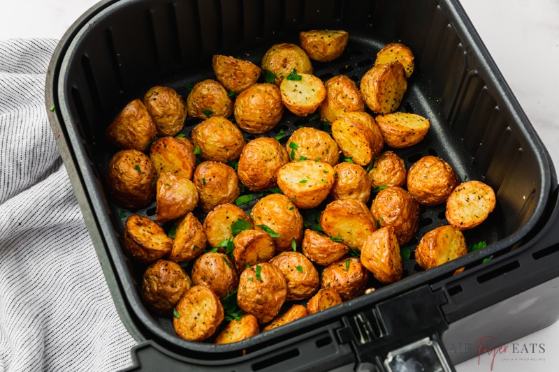 roasted baby potatoes in a black square air fryer basket.