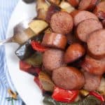 vertical photo of air fryer sausage meal on a white plate