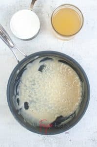 vertical photo showing butter and flour blended in a pan