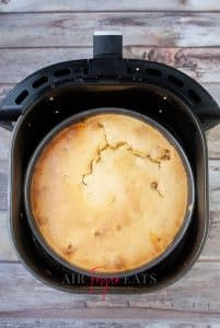 vertical photo showing the cooked air fryer sloppy joe cornbread casserole in the air fryer basket