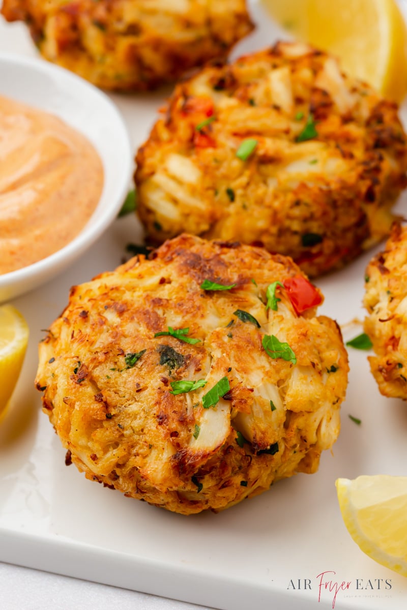 air fryer crab cakes on a plate, viewed from close up.