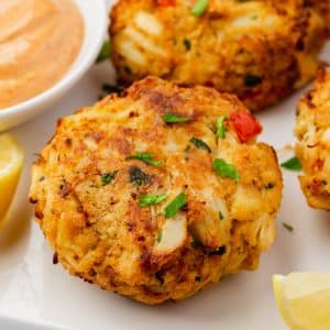 close up on an air fried crab cake garnished with parsley