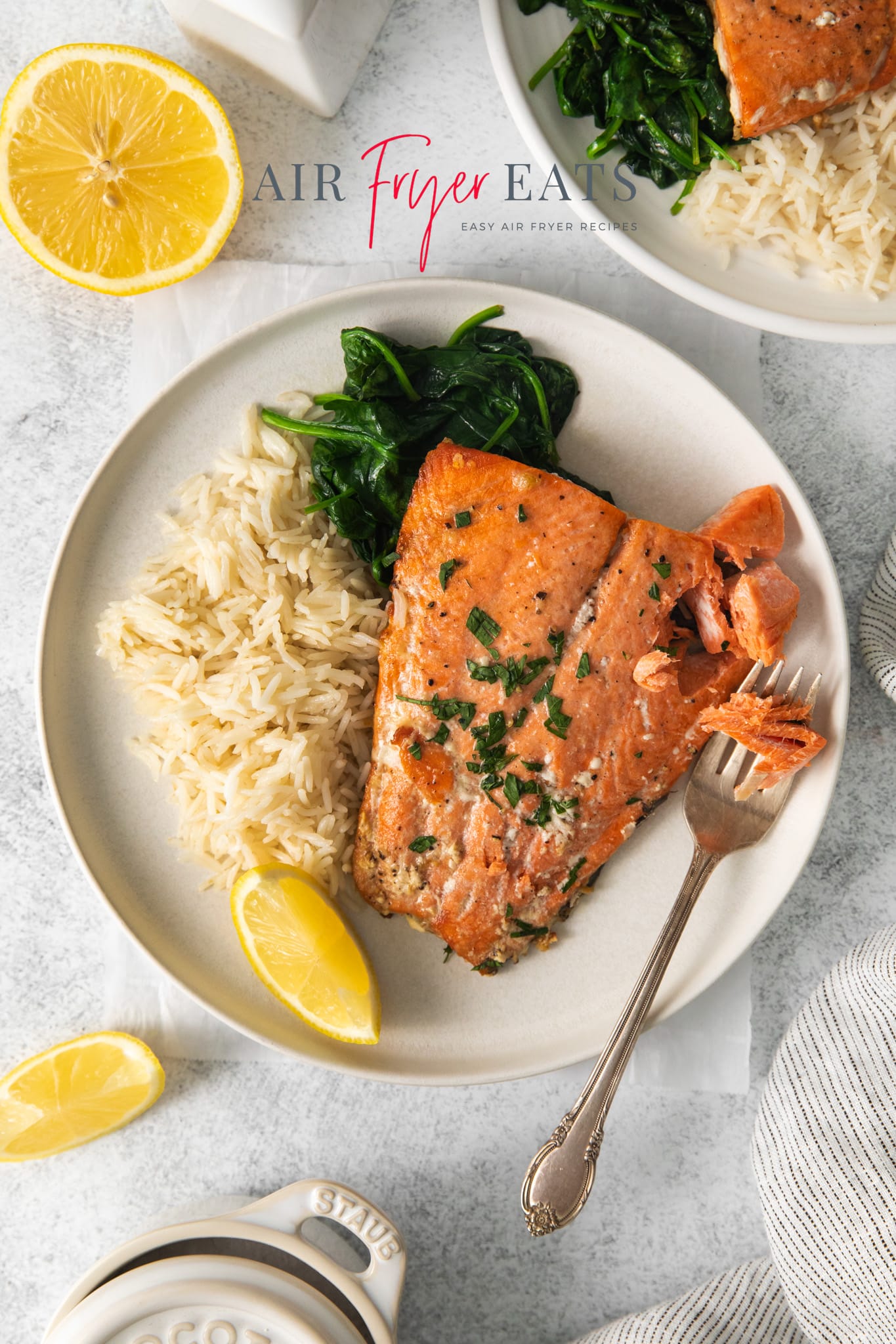 overhead shot of a plate of air fryer salmon with rice and spinach.