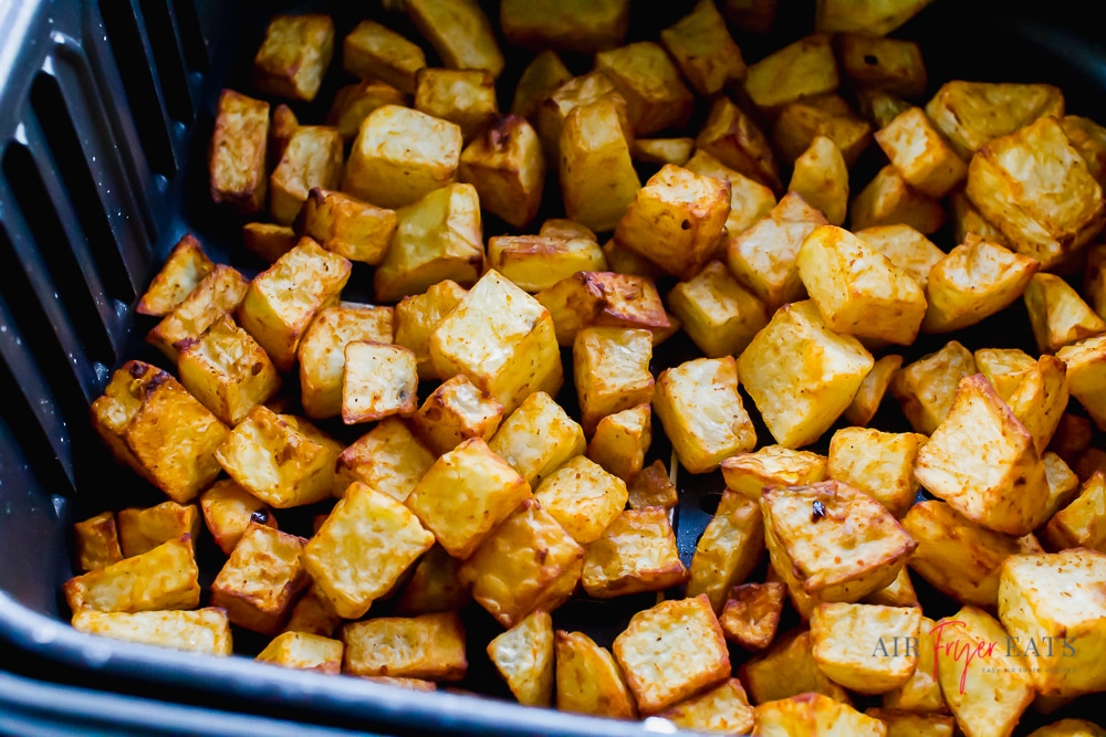 Crispy air fryer breakfast potaoes are cooked in the air fryer. They are golden brown, crispy on the outside, and tender on the inside.