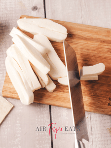 Mozzarella string cheese is cut into small, 1-inch long pieces.